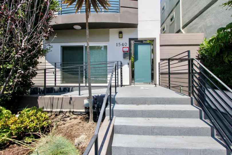 A HOUSE WITH TWO DOORS AND ALSO A NUMBER AT THE WALL AND ALSO A FLOOR AT THE TOP OF THE BUILDING AND STEPS ALSO AVAILABLE WITH RAMPS