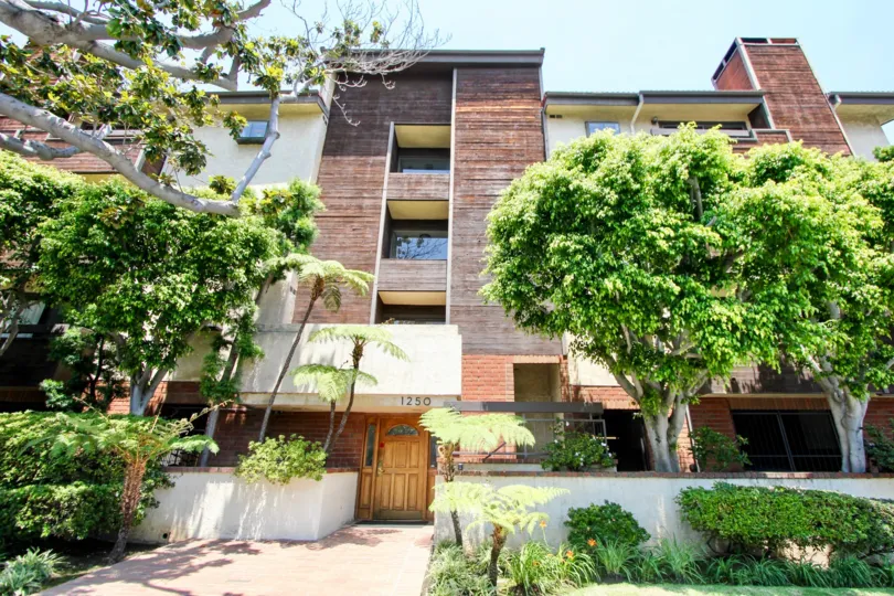 a big building with trees in the front in Amherst Villas II