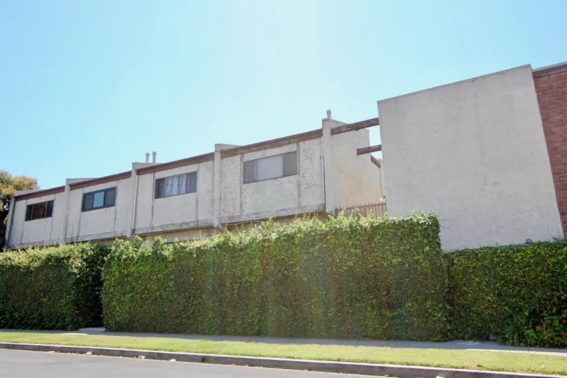 Large privet hedges provide privacy for residents of this old buildling