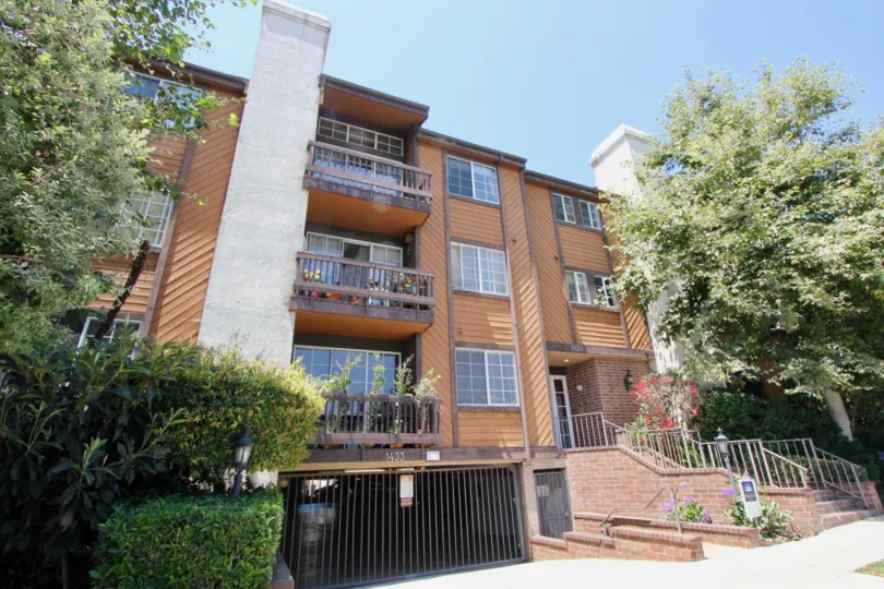 Tall modern architecture and beautiful landscaping adorns this 3 level condo with an underneath parking garage