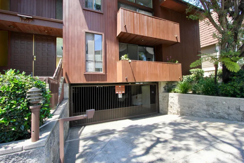This house has wooden exterior and a leading down driveway for parking