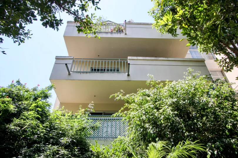 Three white balconies of Bentley Manor with blue sky to the left in West LA, California