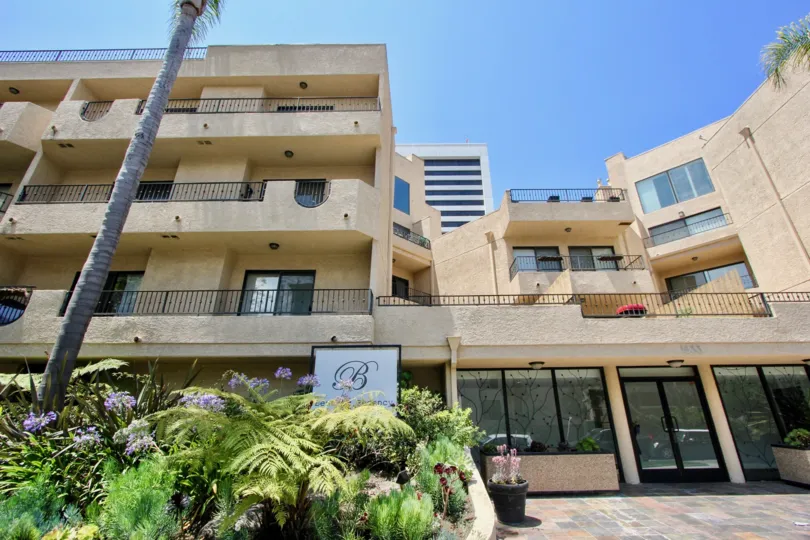 A beautiful building surrounded by lush vegetation in West LA, at the Bentley Regency