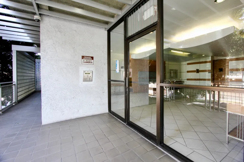 Entrance door to clean titled lobby of Brentview Homes