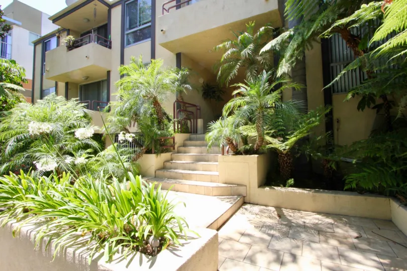 Lushly landscaped jungle-like entry stairs to units at Brentwood Terrace