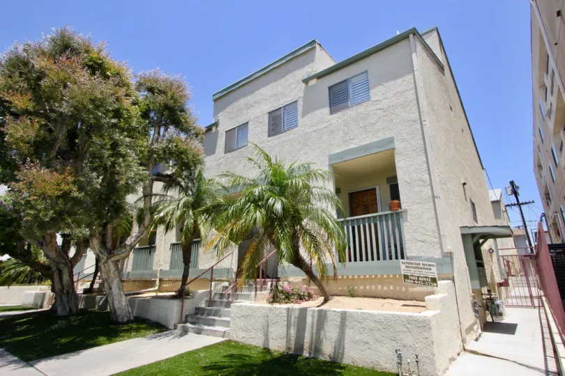Four trees planted in front of A cream colored house at Butler Townhomes in West LA California