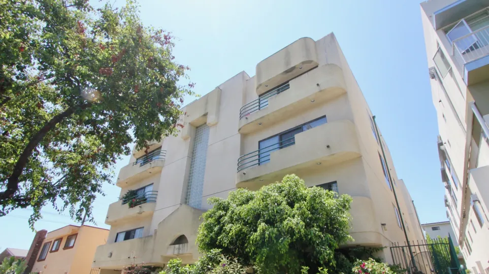 Tree lined street view of the balconies at the building
