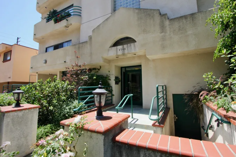 A sunny day in the Colby Luxury Condominiums Townhomes a beautiful house and trees.