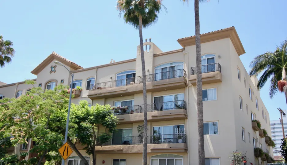 A sunny street front view of Federal Plaza in West LA, California with view of blue sky