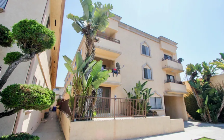 Pink colored block of flats that is beautifully planted with flowers at Fifteen Ten in West LA California