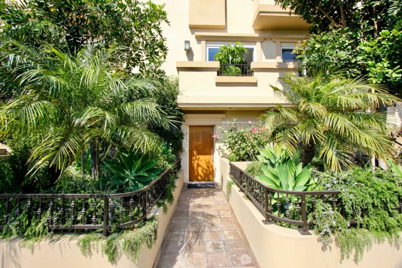 Exterior entrance of house surrounded by vegetation in Granville Homes West LA California