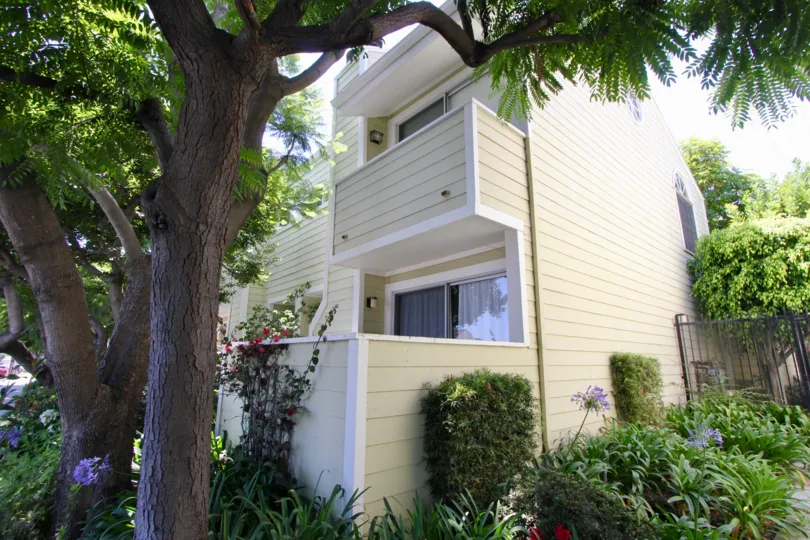 Beautiful Gardens and flowers with large shady trees and trimmed hedges line these West LA townhomes