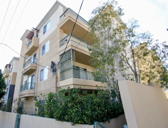 shaded side of four story apartment building with electric wires at Palace Texas