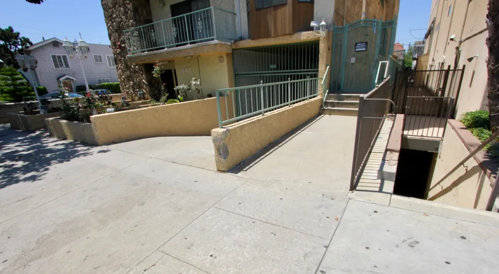 garage with gate, entry way and staircase below home at Regency Chateaux
