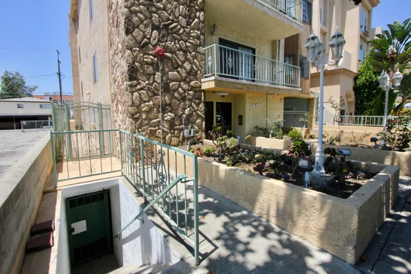 An apartment building with a stone outer wall on a sunny day in the community of Regency Chateaux