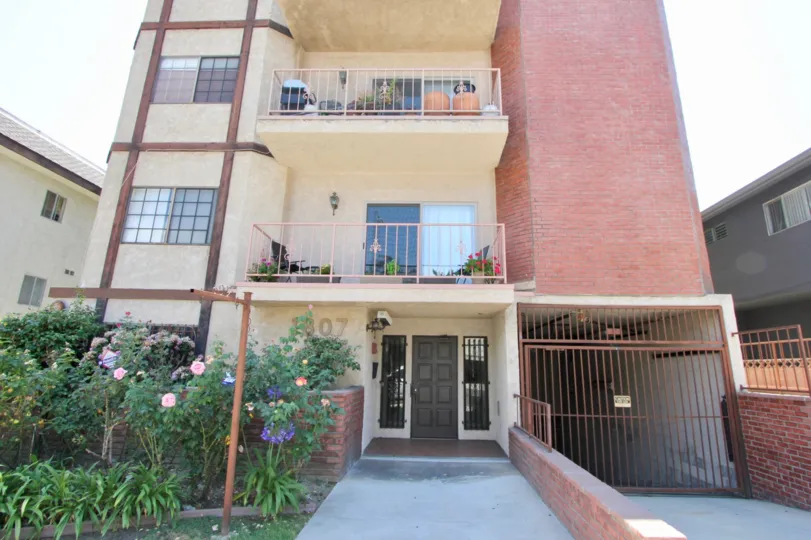 Pink colored 2 story Brick decorated block of Flats at Sunrise Vista Chateau in West LA California
