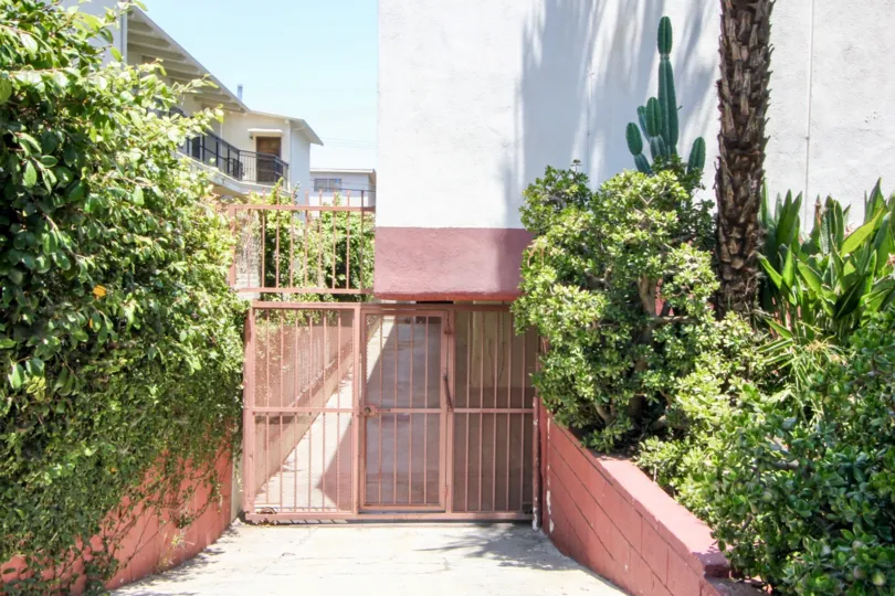 Iron gate entrance and cactus garden tuck the entrance away in a nice way