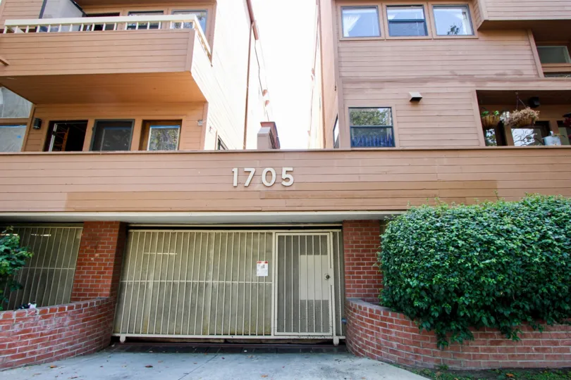 Woody exterior and brick with shrubs and an automatic garage door