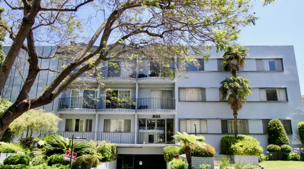 1632 Camden Building has three floor with balcony and surrounded by plants and trees