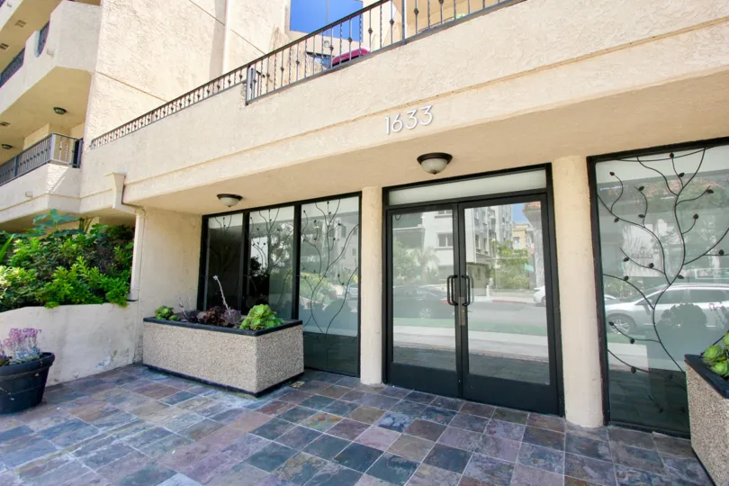 Bottom floor entrance to the 1726 Bentley Regency with a planter box out front