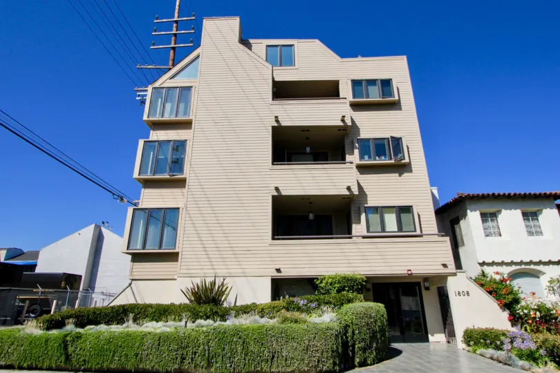 A sunny day in three floor building named 1808 Manning with much enough greenry outside