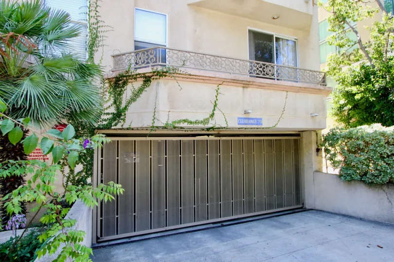 The entrance to a parking garage and the balcony of an apartment in the 1931 Glendon community of Westwood CA