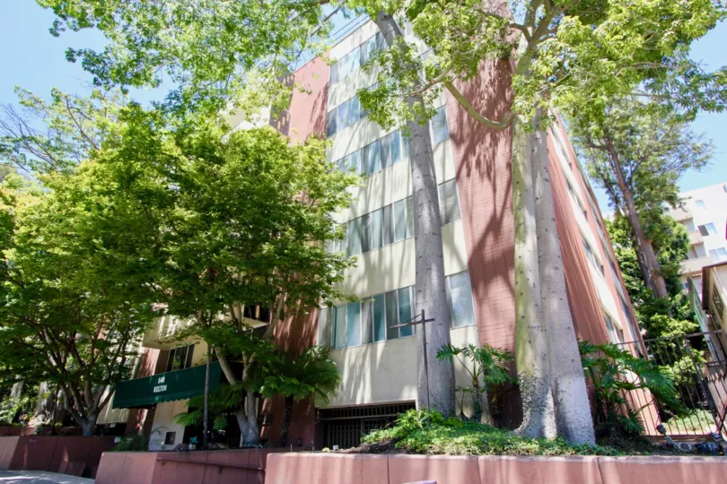 awesome angular view of 540 Kelton with her red and creamy walls surrounded by beautiful trees, Westwood, California