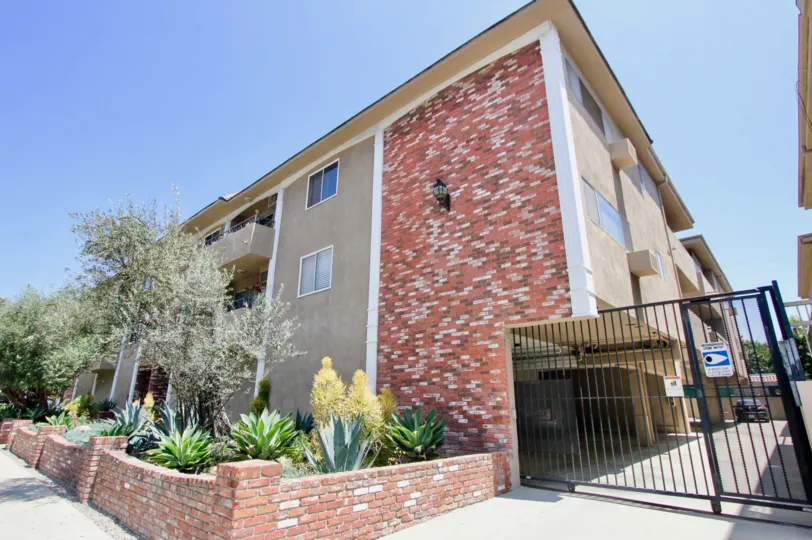 A corner view of Bentley Manor homes with tress near by it