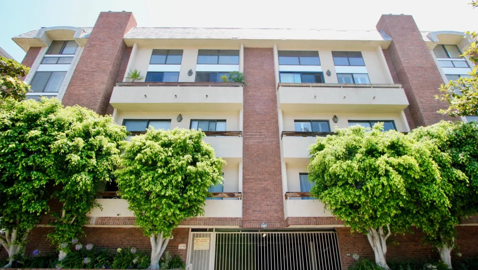 A sunny day the Beverly Glen Villas is looking so good with in front of green leafy trees and plants