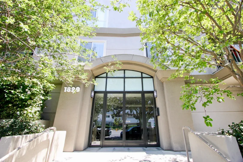 Beverly Landmark II, westwood, California is A beautiful entrance with pretty good gate and lots of greenery including plants and trees. Colourfull flowers are adding life in the picture.