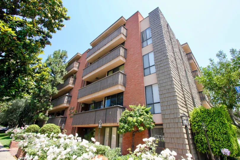 Beverly Lencrest is a Big Building And the Front view is Full of White Flowers