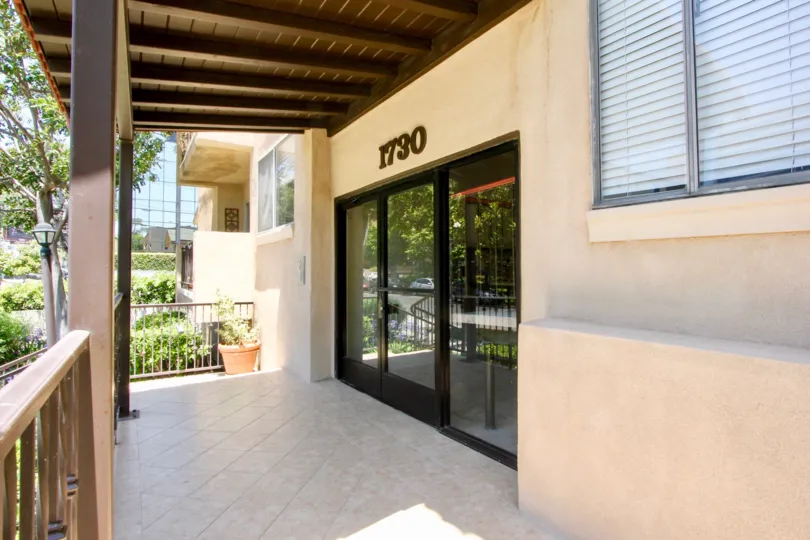 A tan house in the neighborhood of Camden II with a large glass door and brown railings