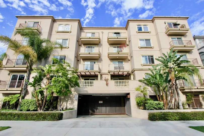 Palm trees and blue skies surround a multi-family housing facility in the La Grange community of Westwood, California.