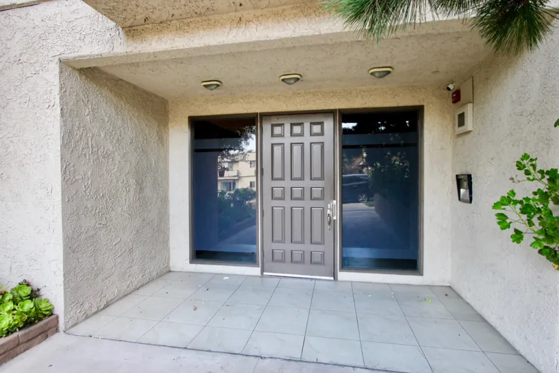 A gray door with tinted windows at a residence in the Park Almayo community