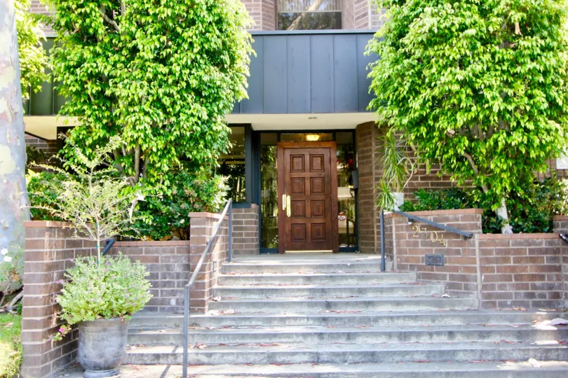 Stairs and wooden door at entryway of Rancho Glen East, Westwood, California