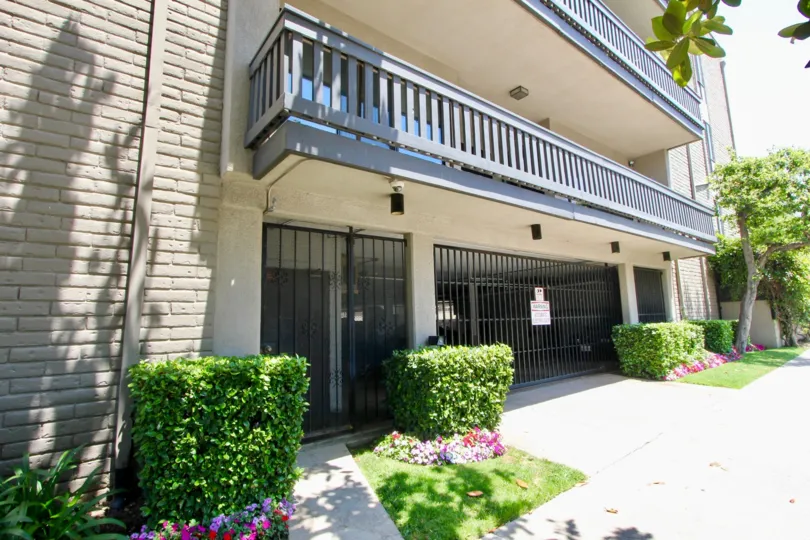 The sunny sidewalk with well trimmed bushes at Rancho Lencrest in Westwood.