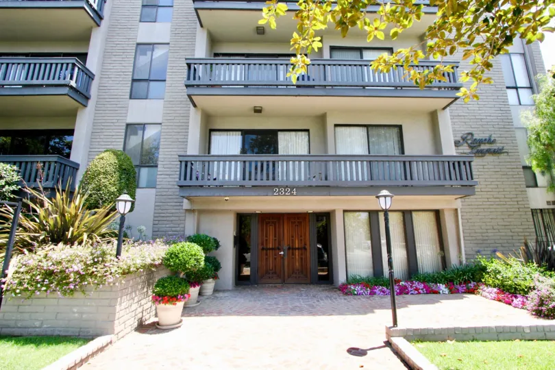 A stunning view of an apartment with colorful flowers and lights infront in Rancho Lencrest.