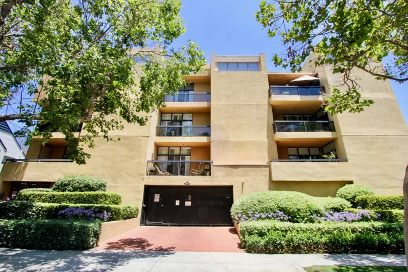 beautiful condo in westwood with greenn shrubs in front