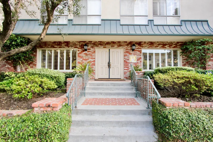 A lovely day at the Westwood House, a residential building with a lovely garden lined walkway.