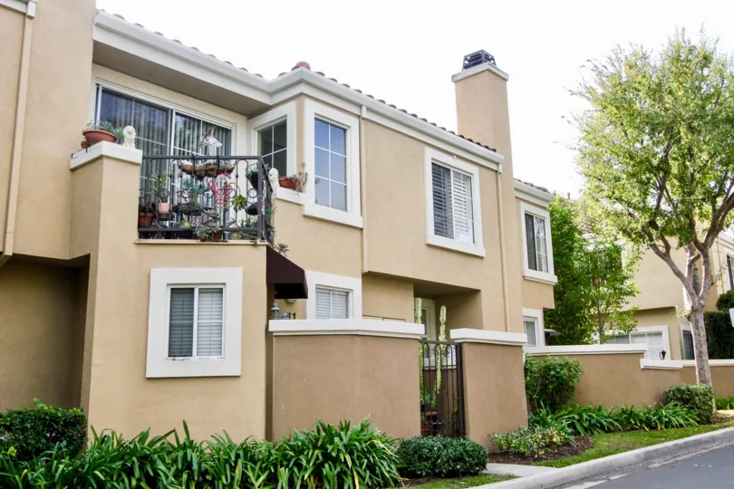 Balcony of House in Applause full of Flower pots and bushes is present outside