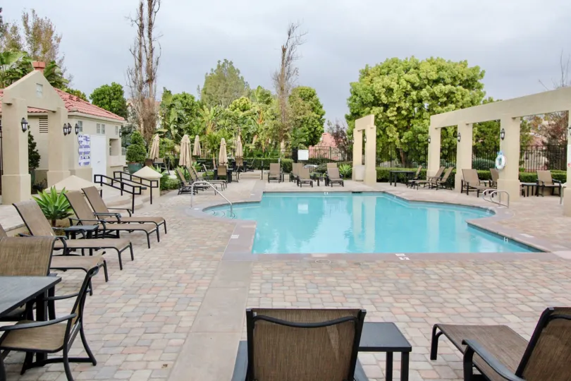 Swimming Pool has benches and chairs with light lamp in California Renaissance