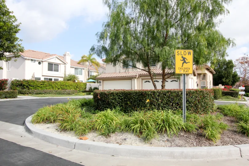 Sunny sky with a tree and a Slow sign in the Cantora Community in Aliso Viejo, CA.
