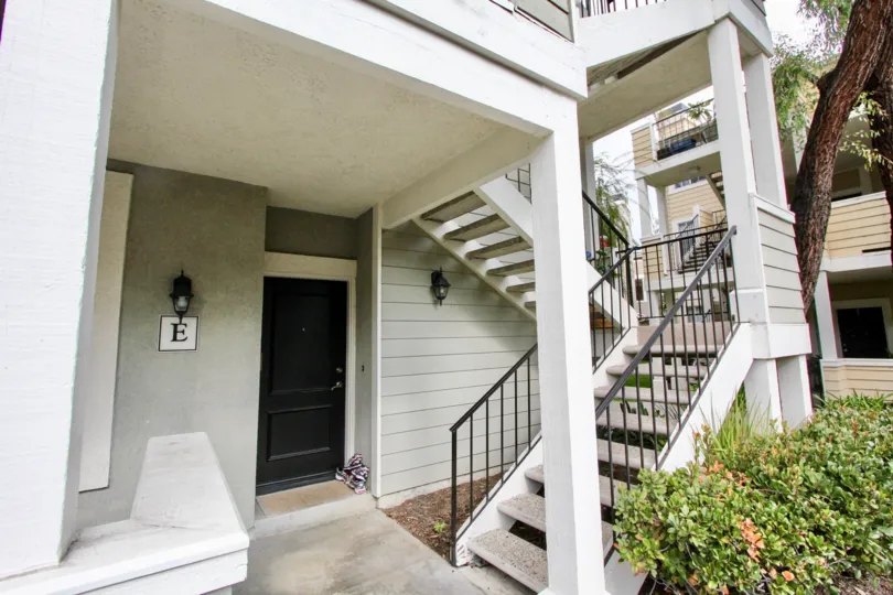 The entrance to unit E in Canyon Villas, with stone steps leading to the second floor.