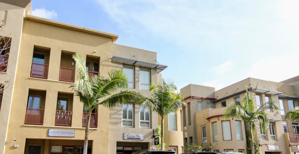 Spanish architecture and palm trees are on display, along with City walk apartments and shops.