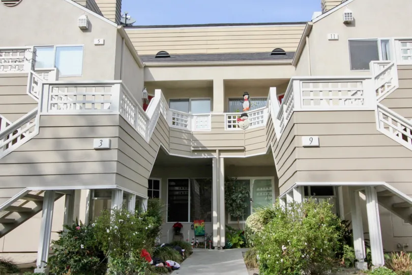 Winter decorations are on display between two units in Glenwood Village.