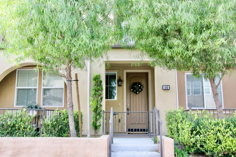 THE 160 APARTMENT IN THE HARBOR STATION WITH THE PLANTS, TREES, WOODEN DOOR