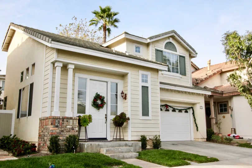 A sunny day beautiful building in the Harvest with some shrubs and small lawn also