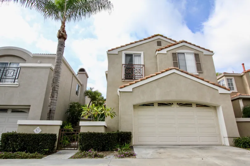 2 storey home with attached double car garage, stucco siding, decent side yards and Spanish style roof at the Islands