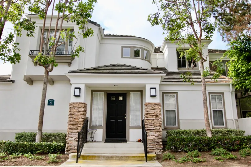 Stone accentuates white columns at the front of a La Mirage home.