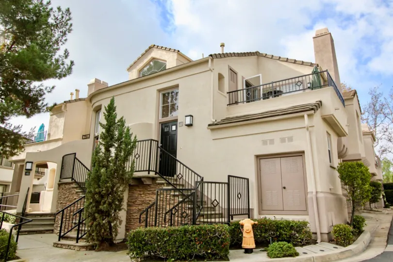 A bright day in the La Mirage with a house and staircase.